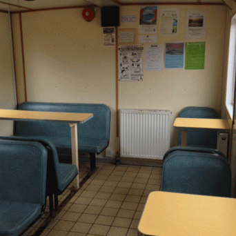 a kitchen with a stove top oven sitting in a chair