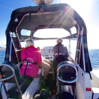 a group of people in a boat on a body of water