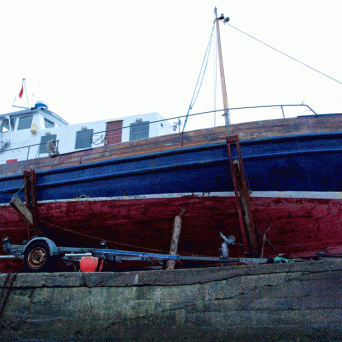 a boat is docked next to a body of water