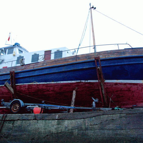 a boat is docked next to a body of water