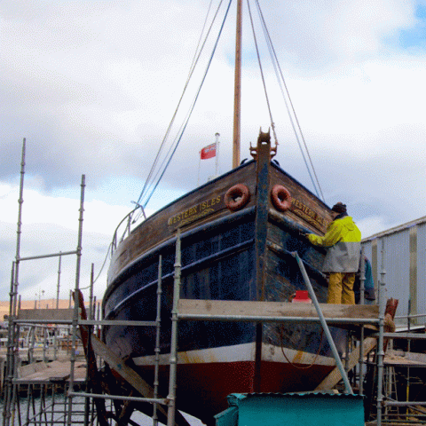 a boat is docked next to a body of water