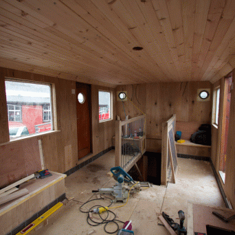 a train on the floor next to a window