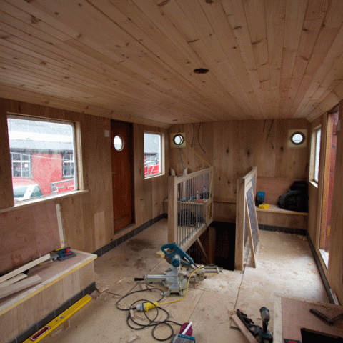 a train on the floor next to a window