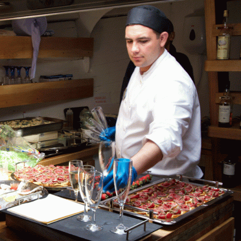 a person standing in a kitchen preparing food