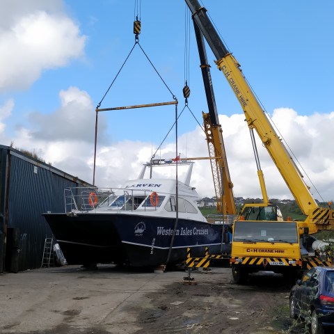 a yellow boat sitting in the sand