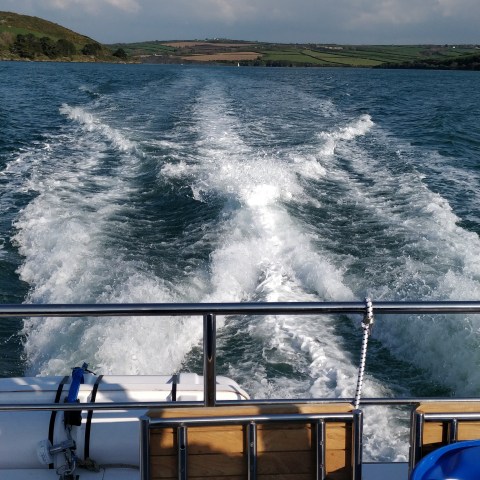 a person driving a boat in the water
