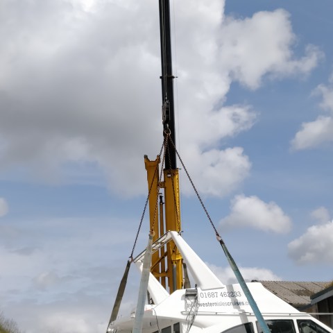 a boat sitting on top of a blue cloudy sky
