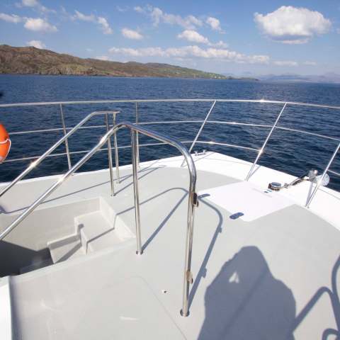 a close up of a boat next to a body of water