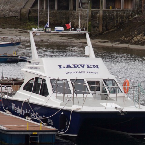 a boat is docked next to a body of water