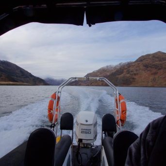 a person sitting on top of a snow covered bridge