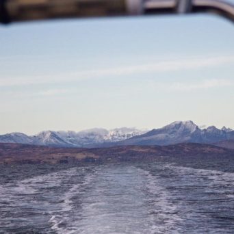 a body of water with a mountain in the background