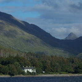 a large body of water with a mountain in the background