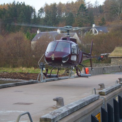 a group of people riding on the back of a bench in a park