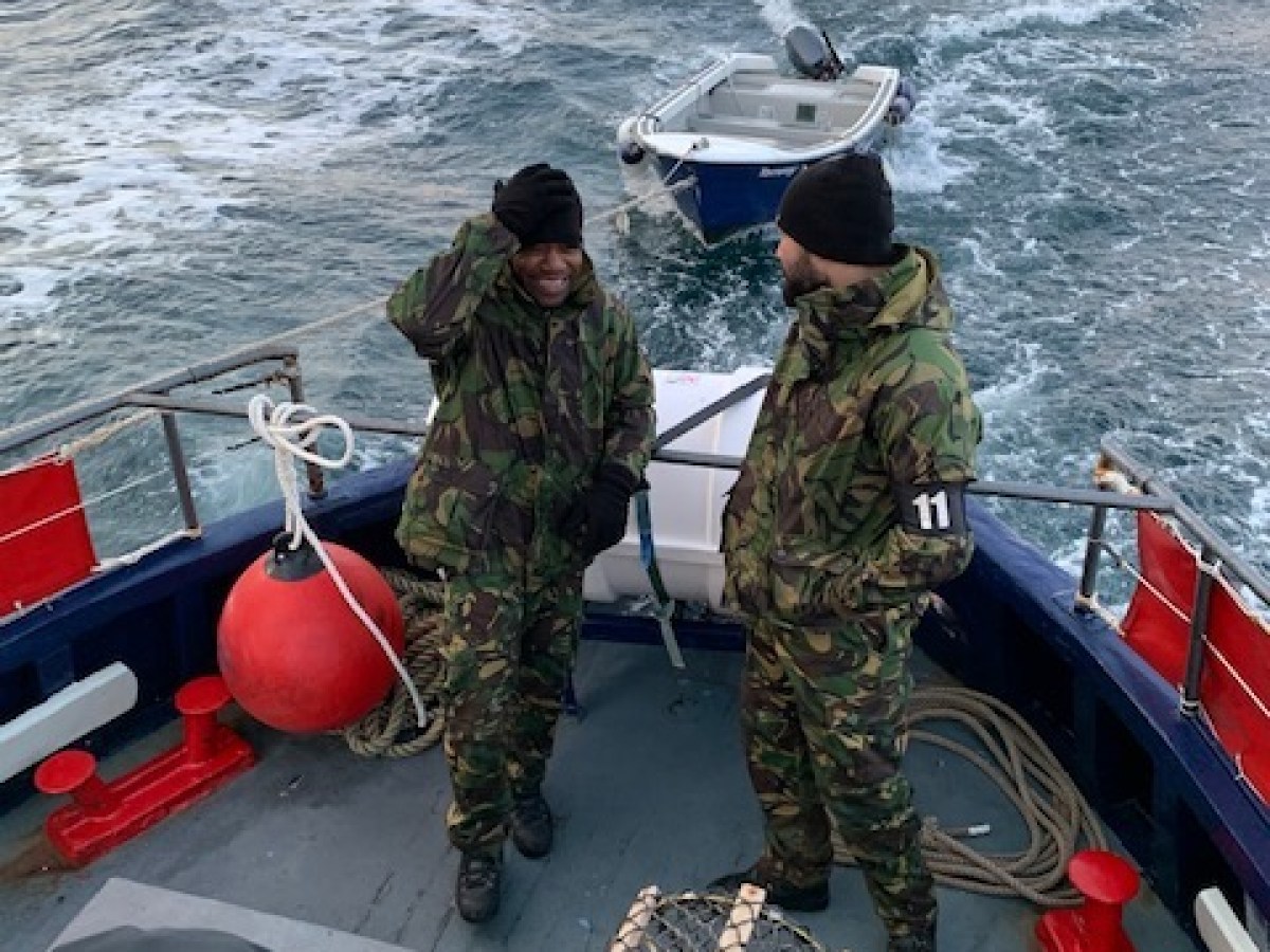 a group of people in a boat on a body of water