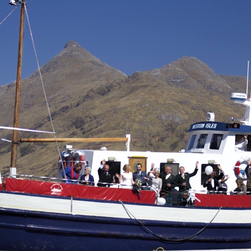a group of people in a small boat in a body of water