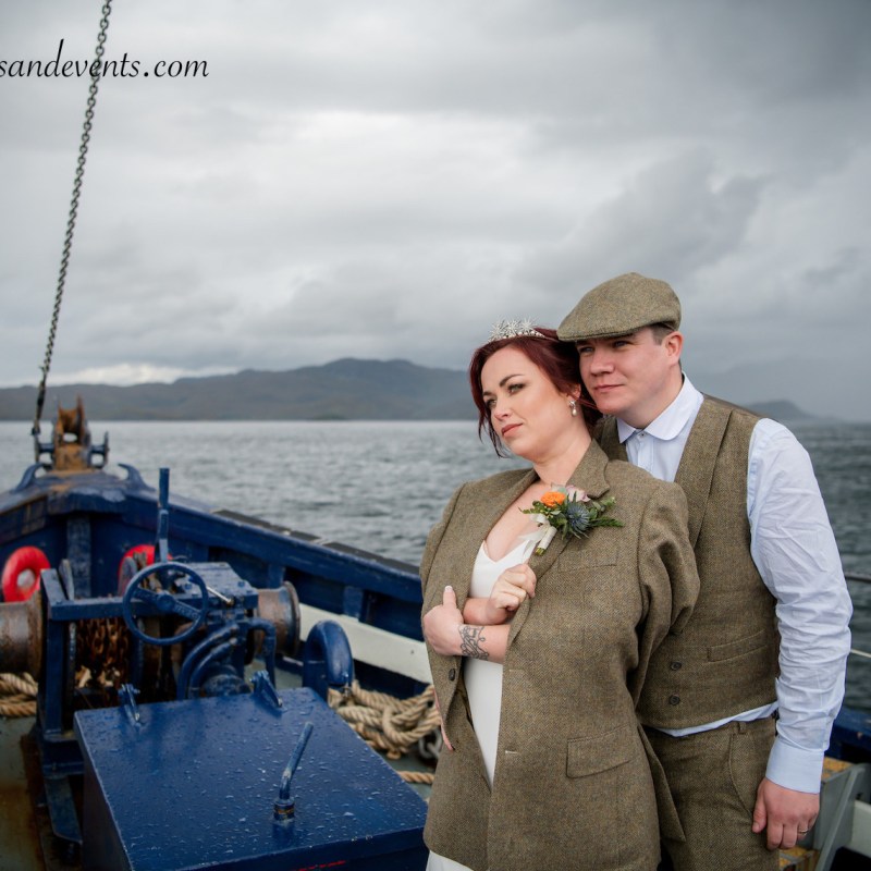 a man and a woman standing in front of a boat