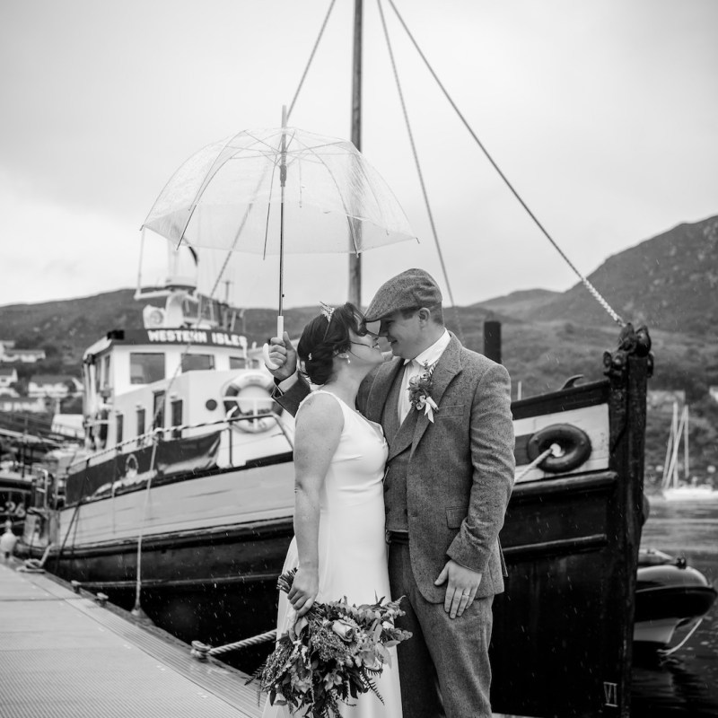 a man and a woman standing on a bridge