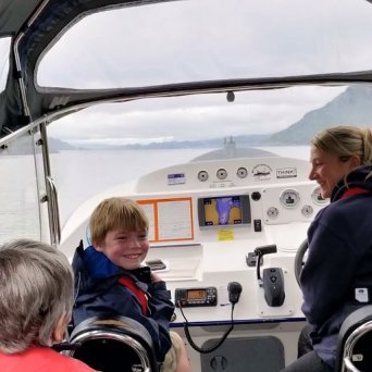 a group of people standing around a plane