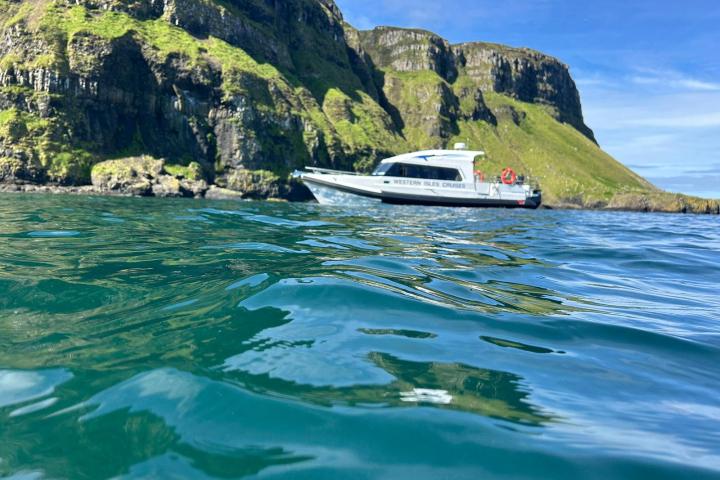 a small boat in a body of water with a mountain in the background
