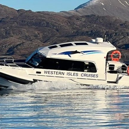 a small boat in a body of water with a mountain in the background